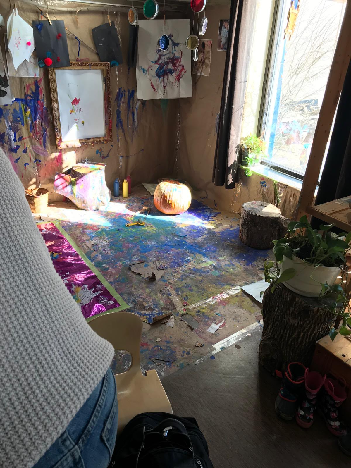 A bright child art studio filled with paintings